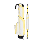 A full shot of Loma golf bag in Mindy Lemon laying flat sideways beside its single strap