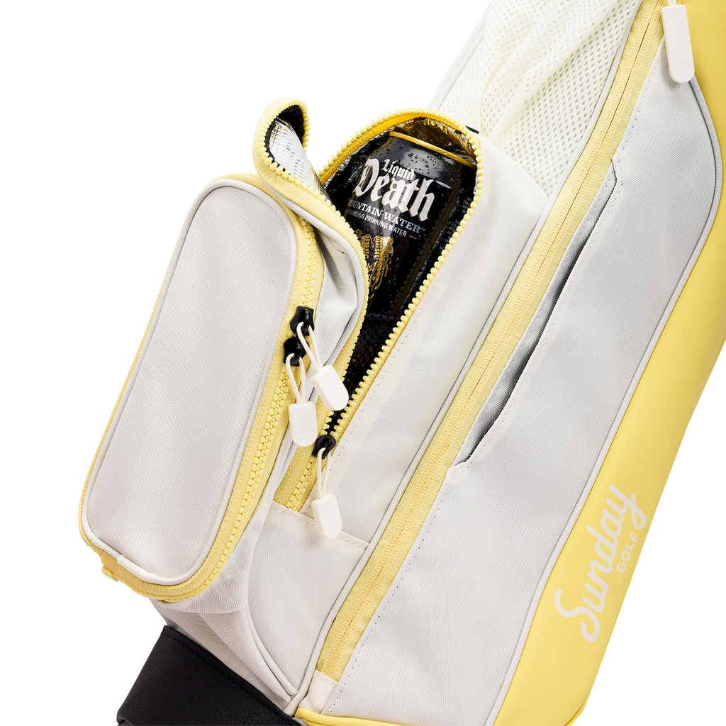 A close up shot of Mindy Lemon Loma golf bag's insulated pocket with a canned drink inside