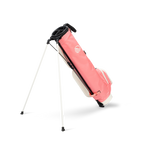 A full shot of standing Loma XL golf bag in coral facing backward