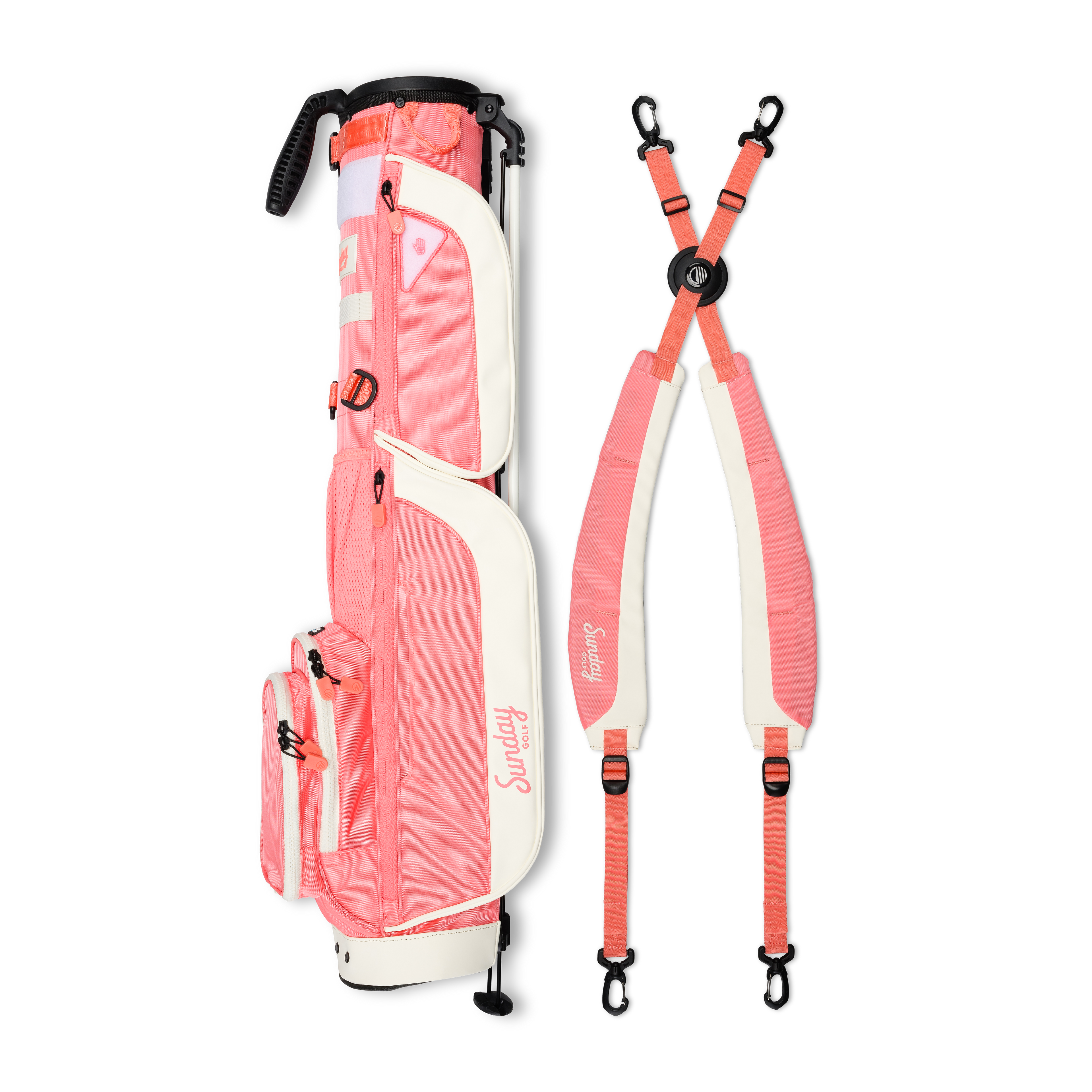 A full shot of Loma XL golf bag in coral laying flat sideways beside its double strap