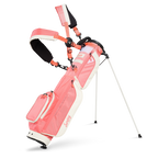 A full front shot of standing Loma XL golf bag in coral with double strap