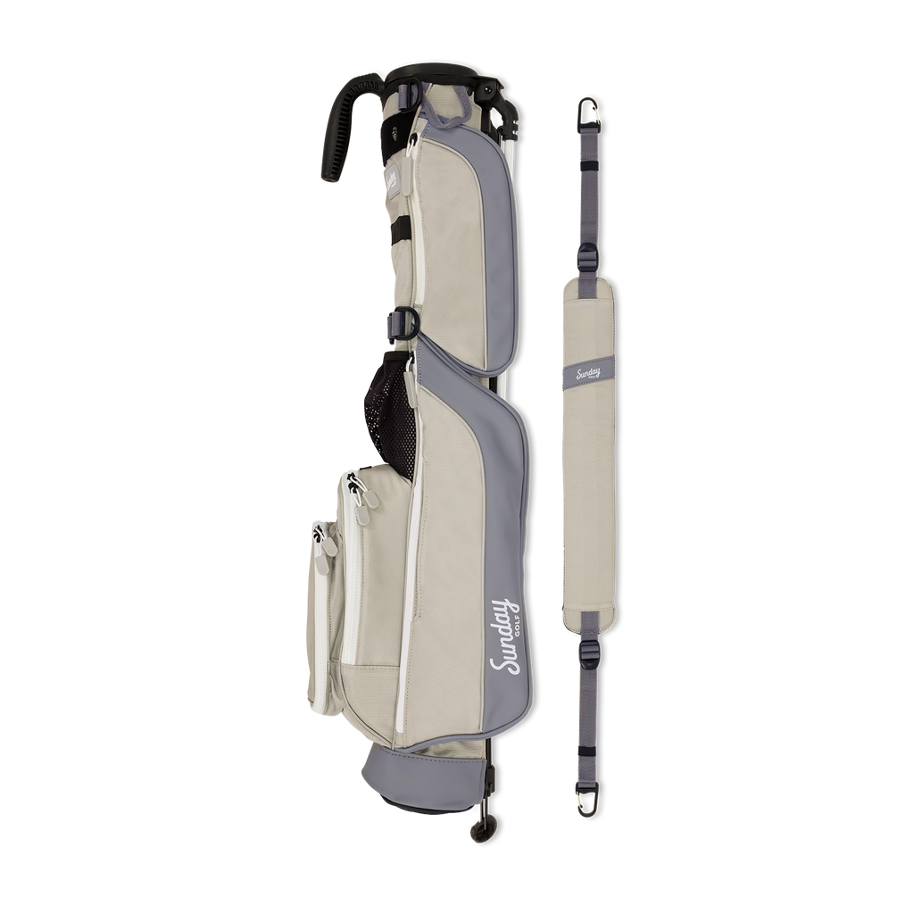 A full shot of Loma golf bag in Cool Gray laying flat sideways beside its single strap

