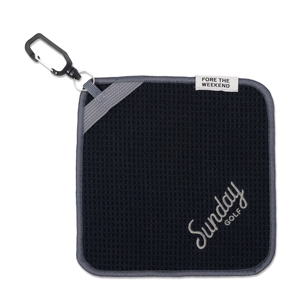Black and gray magnetic towel with carabiner and 'Fore the Weekend' tag, featuring 'Sunday Golf' branding.