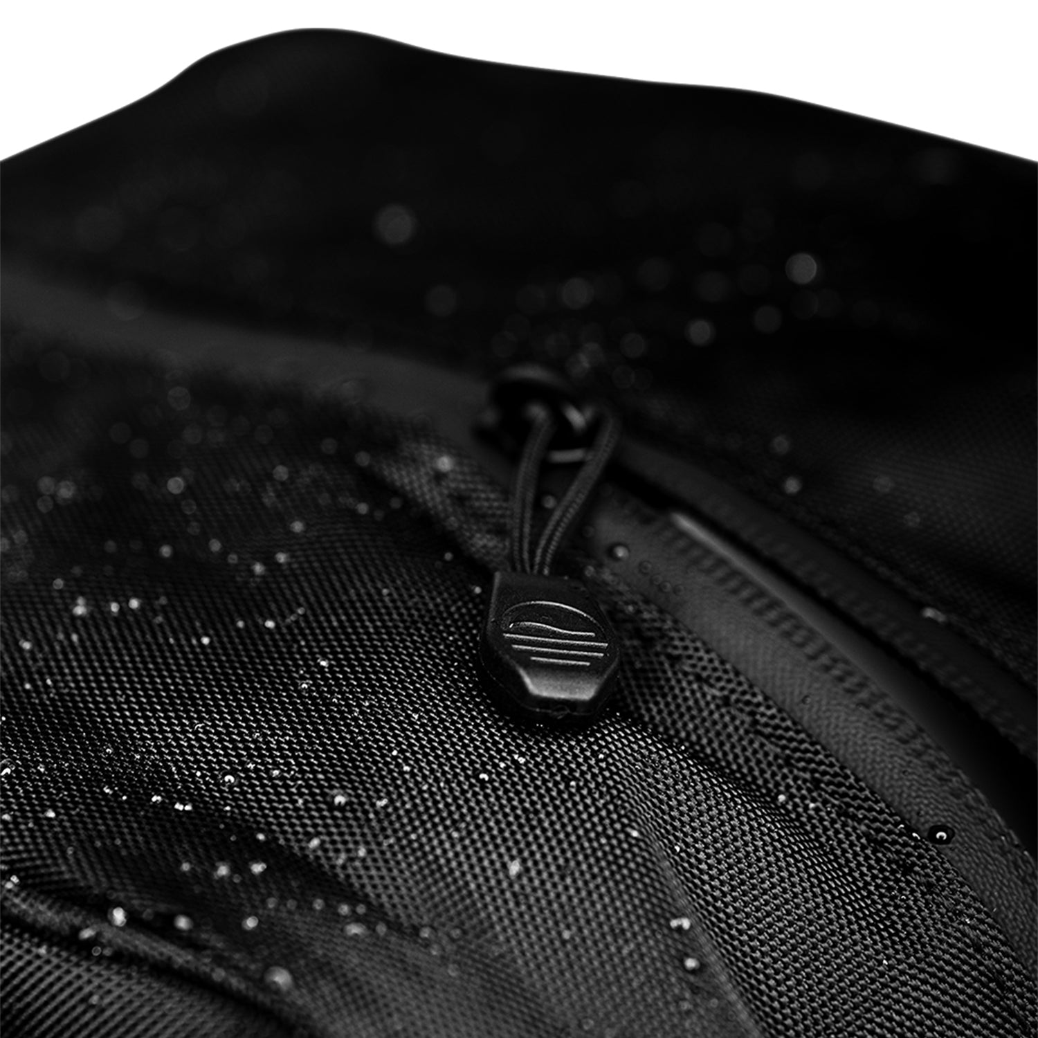 A close up of matte black rain hood's water-repellent zipper