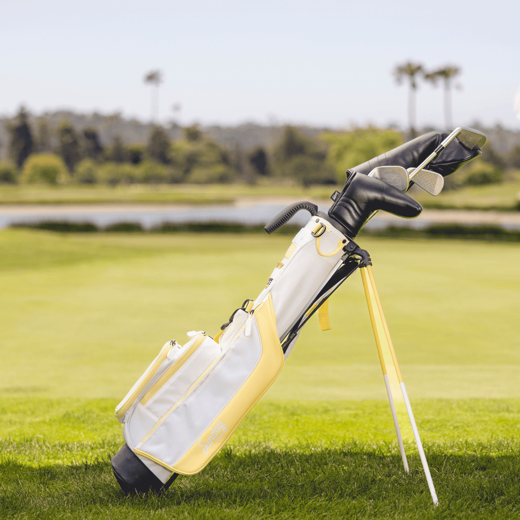 Golf bag with clubs on a golf course