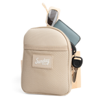 Toasted almond nickel bag valuables pouch unzipped with items showing from inside