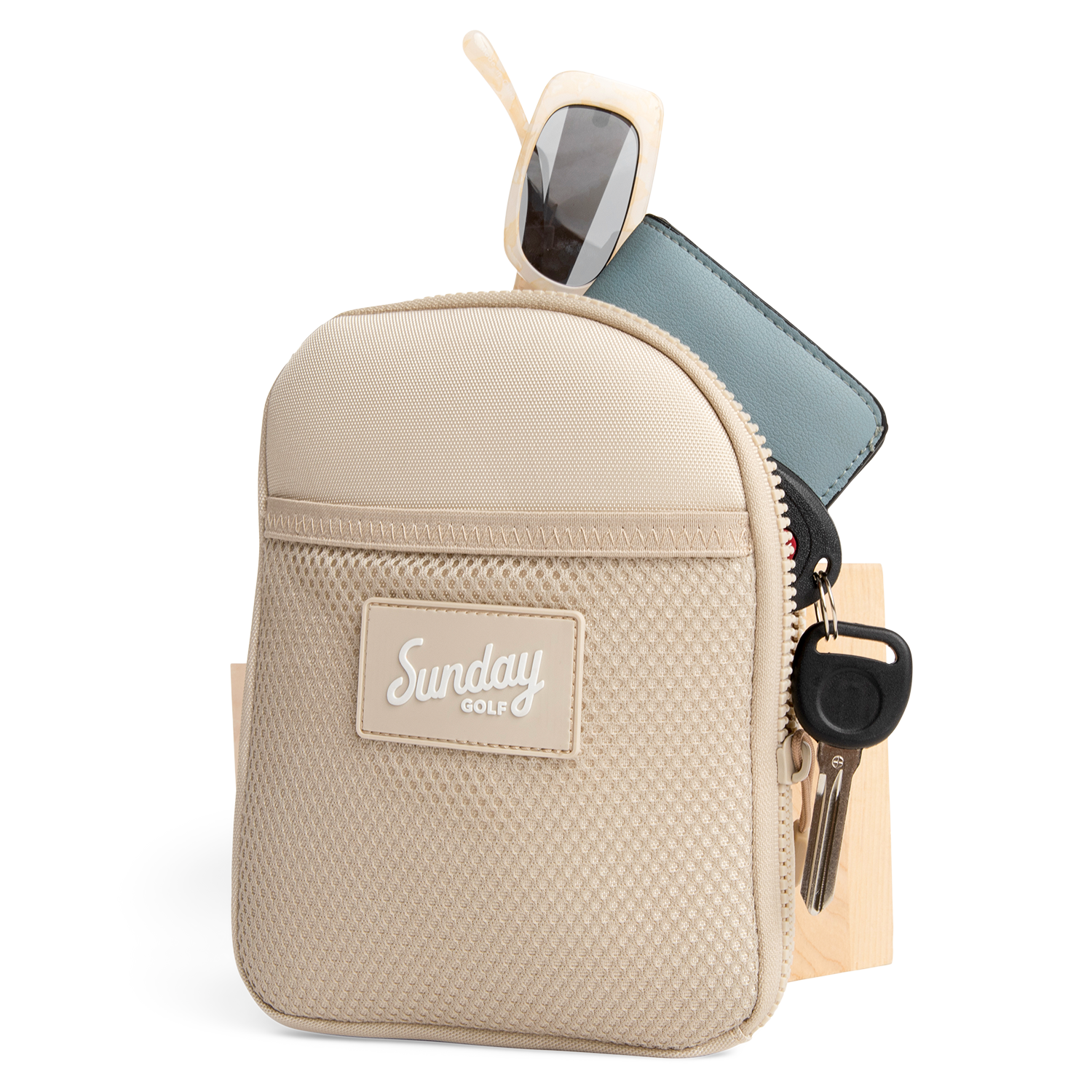 Toasted almond nickel bag valuables pouch unzipped with items showing from inside