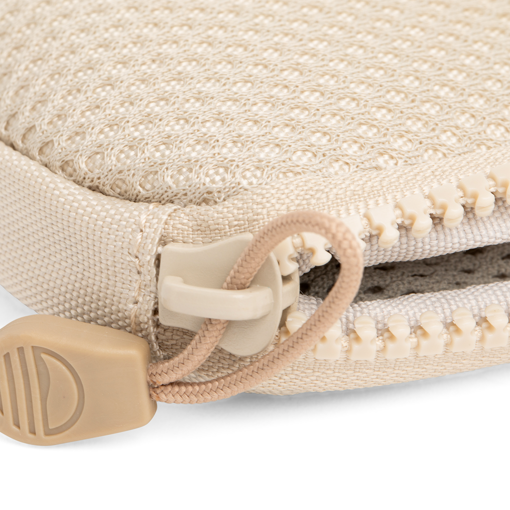 A close up shot of toasted almond nickel bag's zipper