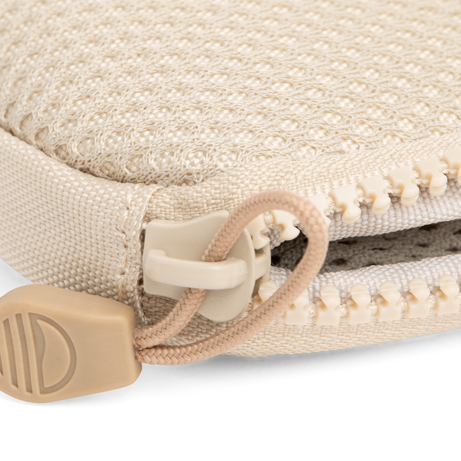 A close up shot of toasted almond nickel bag's zipper