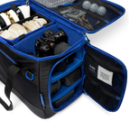Sunday Golf's Creator Duffle Bag showcasing compartments containing camera equipment, accessories, and golf balls.