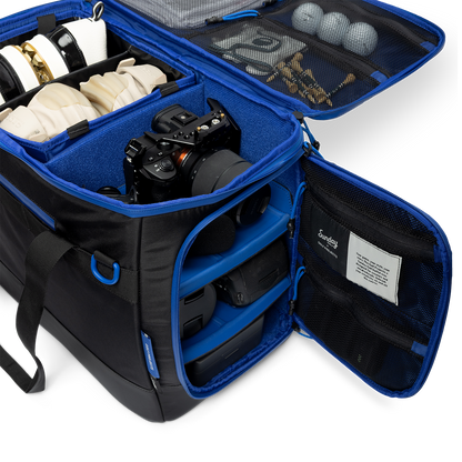 Sunday Golf's Creator Duffle Bag showcasing compartments containing camera equipment, accessories, and golf balls.