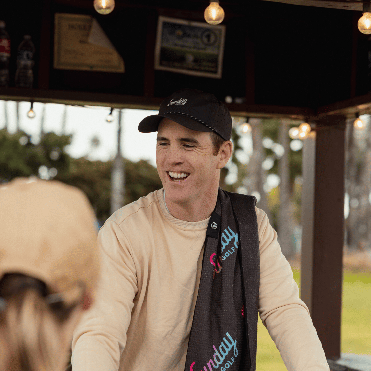 Miami Vice golf towel on Ronan's shoulder