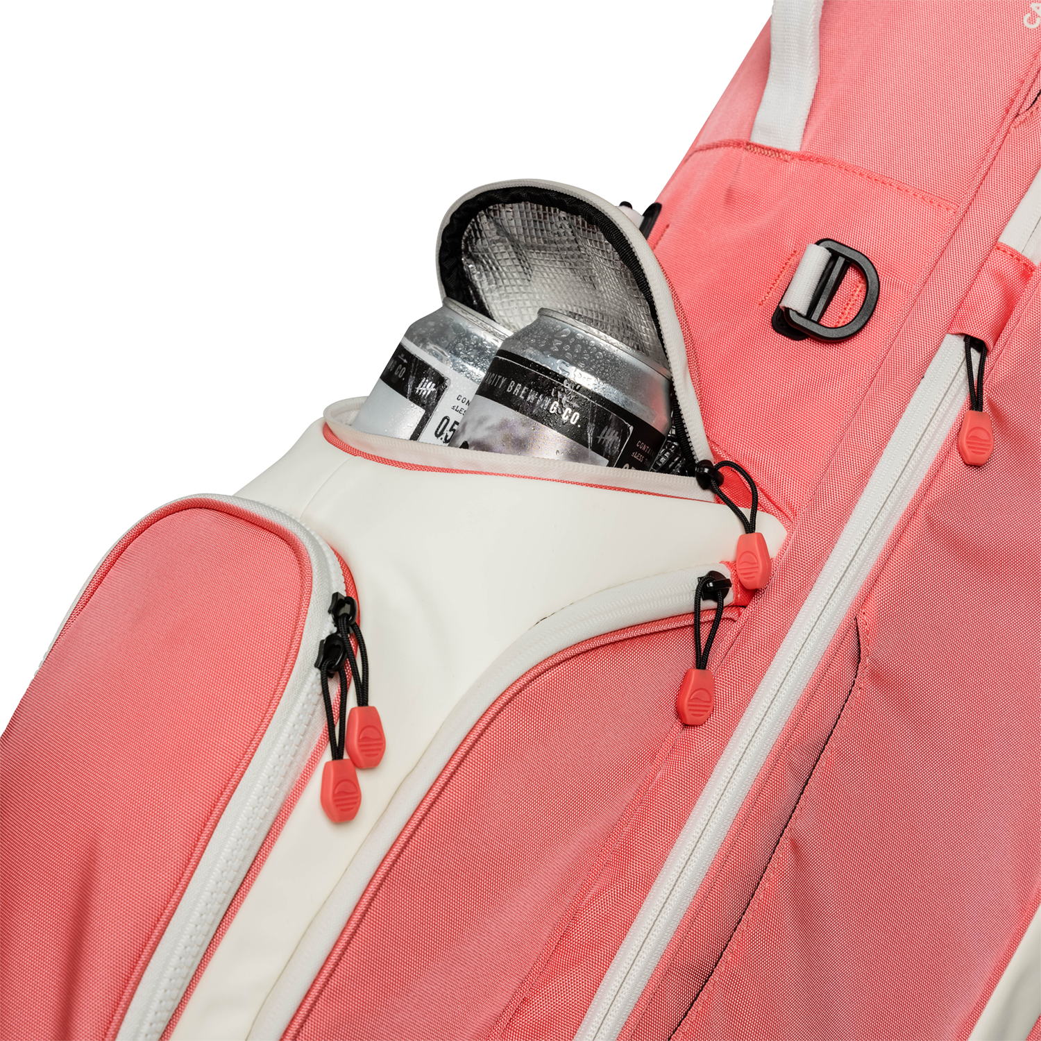 A close up shot of coral Ryder golf bag's frosty pocket with canned drinks inside