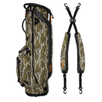 A full shot of Ryder golf bag in mossy oak bottomland laying flat sideways beside its double strap