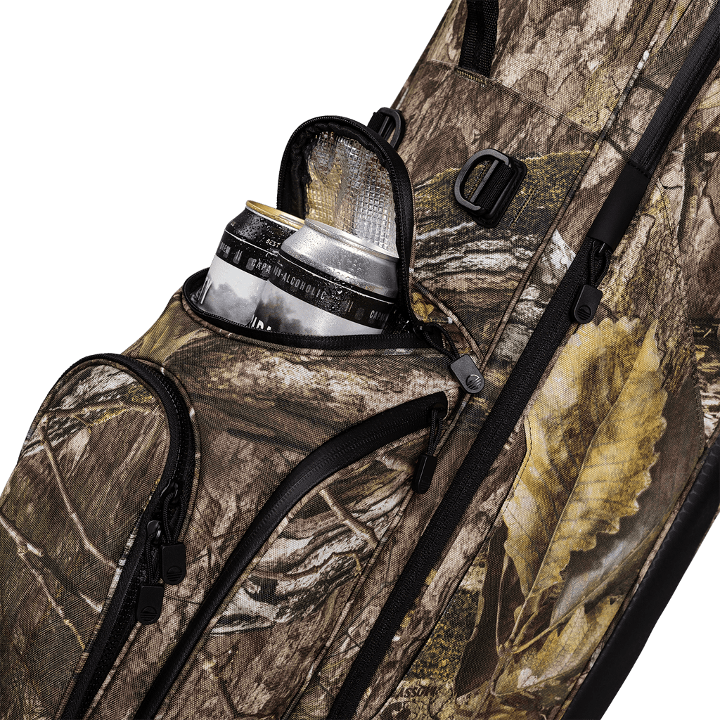 A close up shot of mossy oak country dna Ryder golf bag's frosty pocket with canned drinks inside