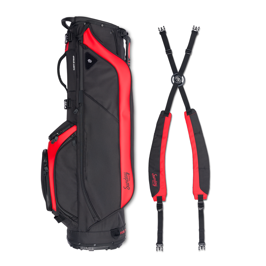 A full shot of Ryder golf bag in blackjack laying flat sideways beside its double strap
