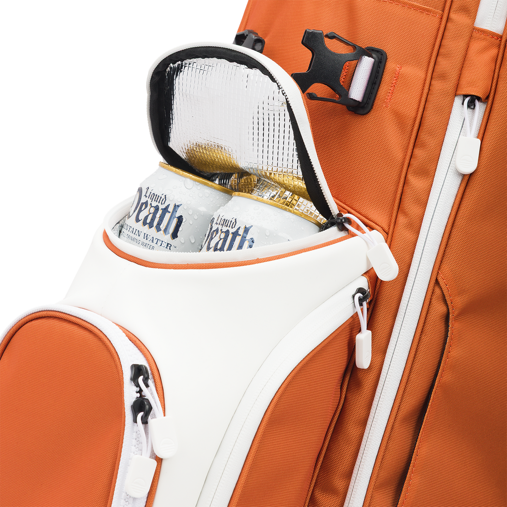 A close up shot of burnt orange Ryder golf bag's frosty pocket with canned drinks inside