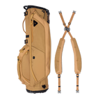 A full shot of Ryder golf bag in clay thompson laying flat sideways beside its double strap
