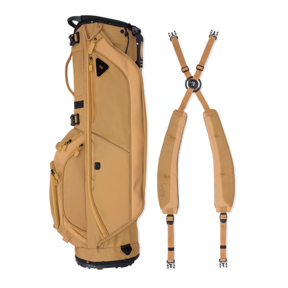 A full shot of Ryder golf bag in clay thompson laying flat sideways beside its double strap
