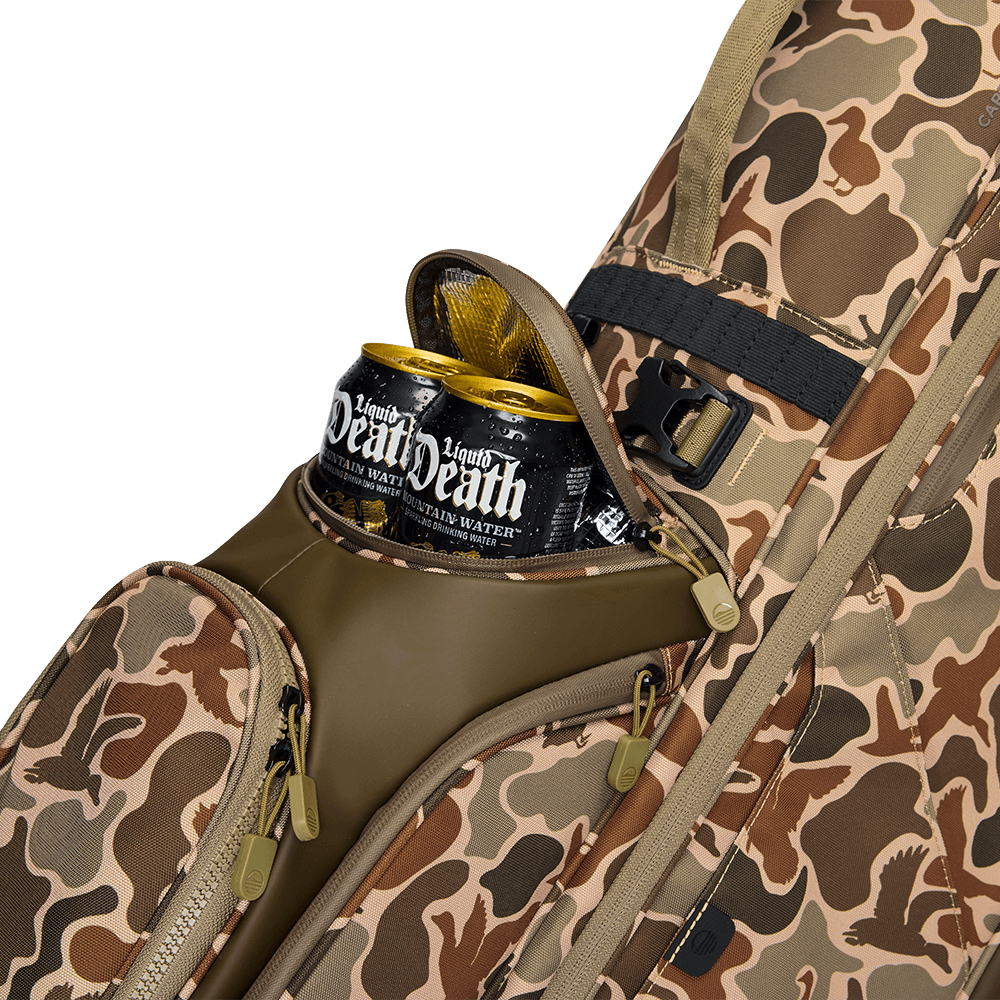 A close up shot of Duck Camo Ryder golf bag's frosty pocket with canned drinks inside
