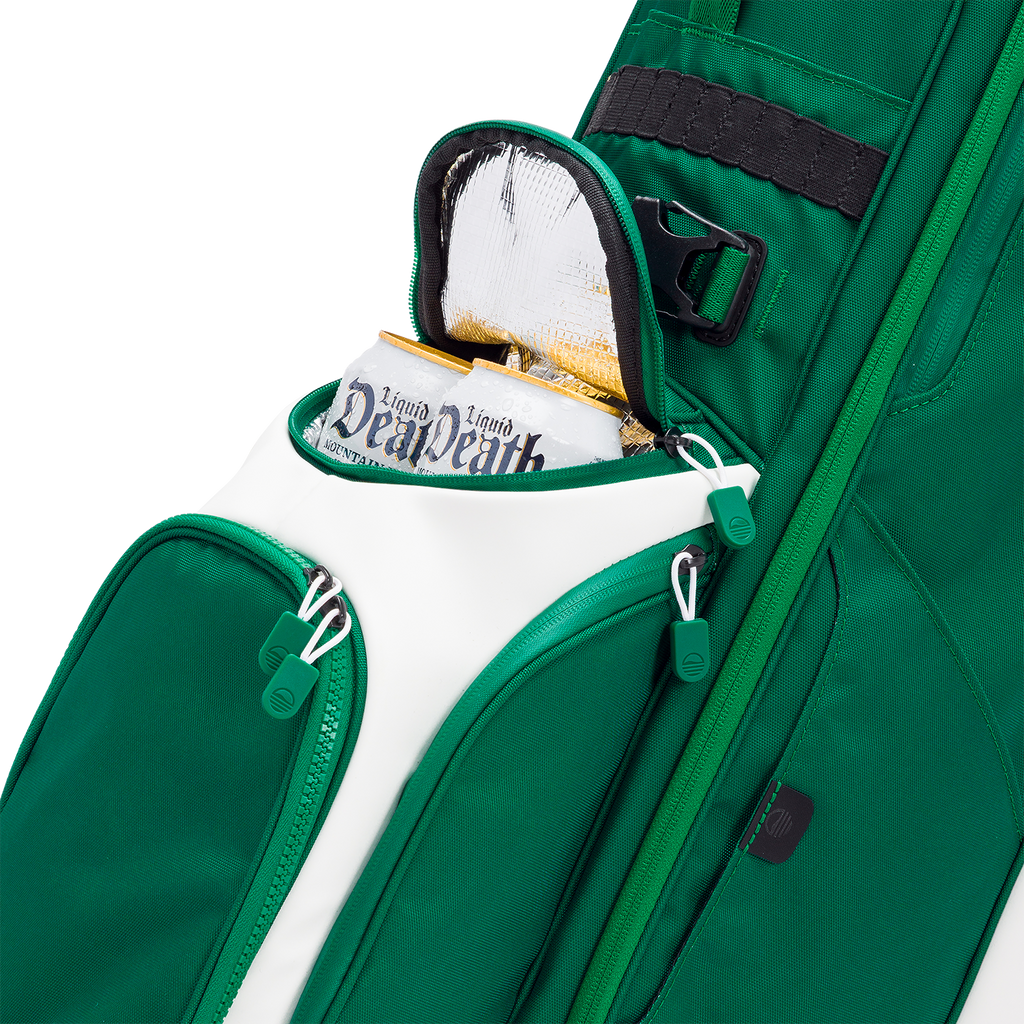 Green golf bag with a white accent and 'Liquid Death' cans peeking out, on a white background.