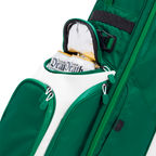 Green golf bag with a white accent and 'Liquid Death' cans peeking out, on a white background.