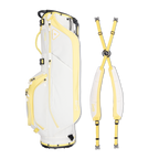 A full shot of Ryder golf bag in mindy lemon laying flat sideways beside its double strap
