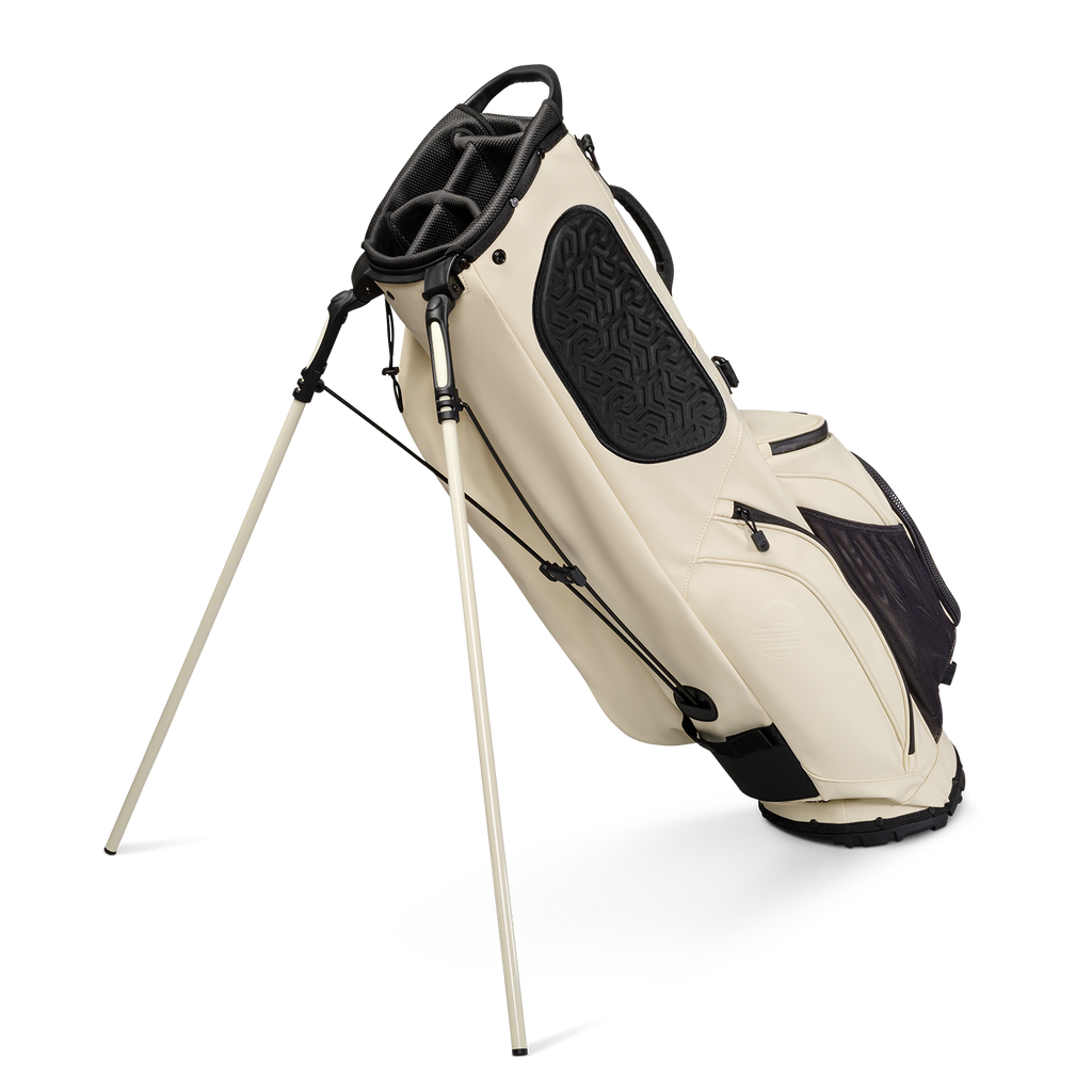 A full shot of standing Ryder S-Class golf bag in cream vegan leather facing backward