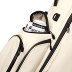 A close up shot of cream vegan leather Ryder S-Class golf bag's frosty pocket with canned drinks inside