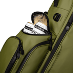 A close up shot of olive vegan leather Ryder S-Class golf bag's frosty pocket with canned drinks inside