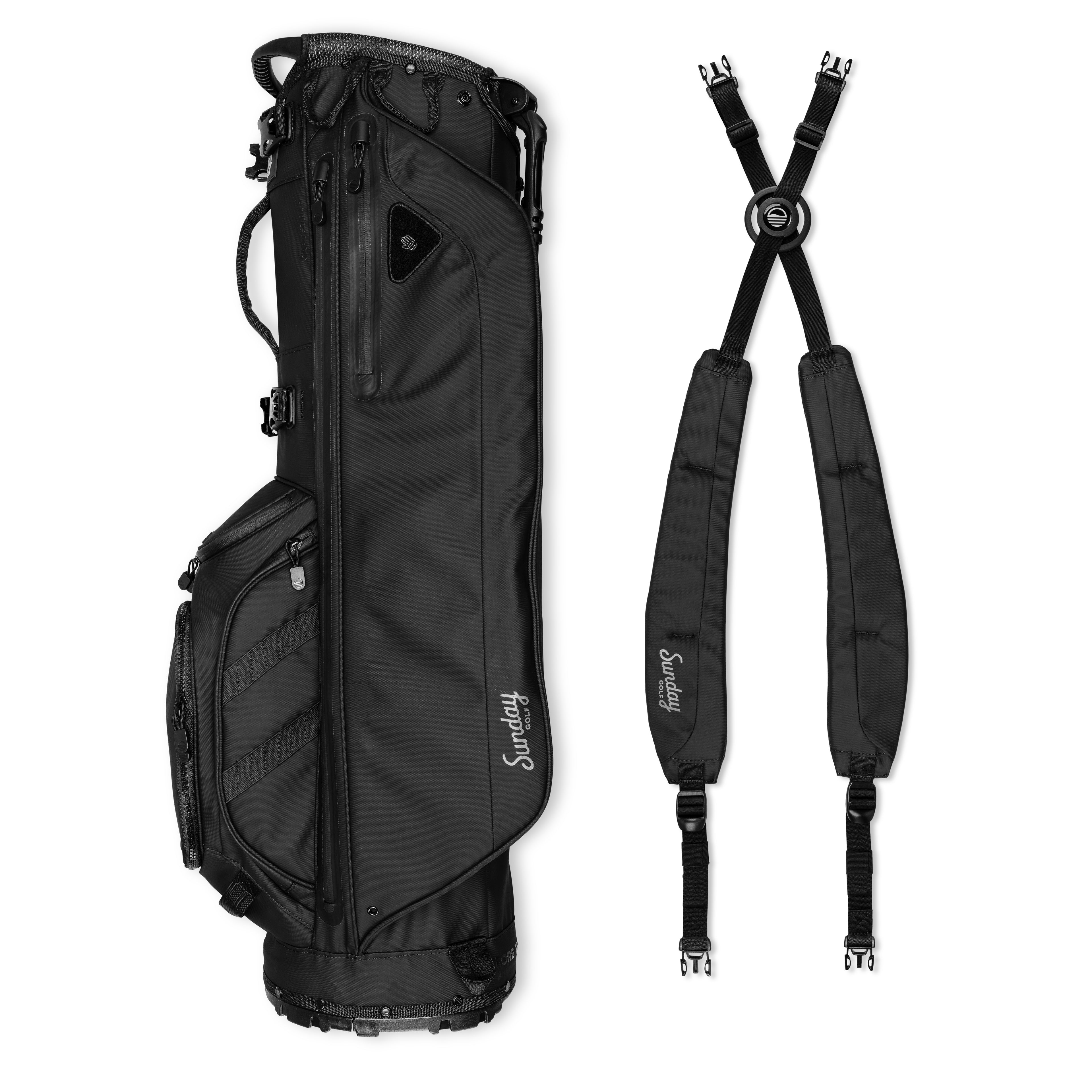 A full shot of storm Ryder golf bag in evergreen laying flat sideways beside its double strap
