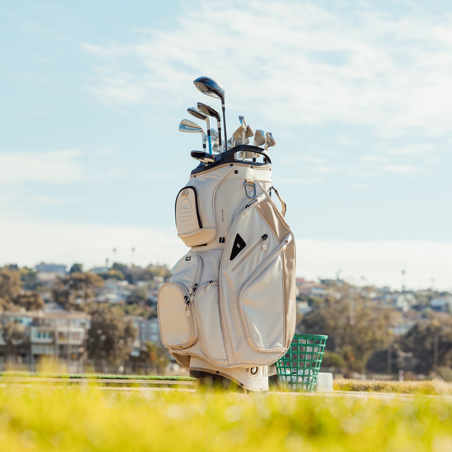 Front shot of Big Rig golf bag in toasted almond on the course showing the pockets and some of its features