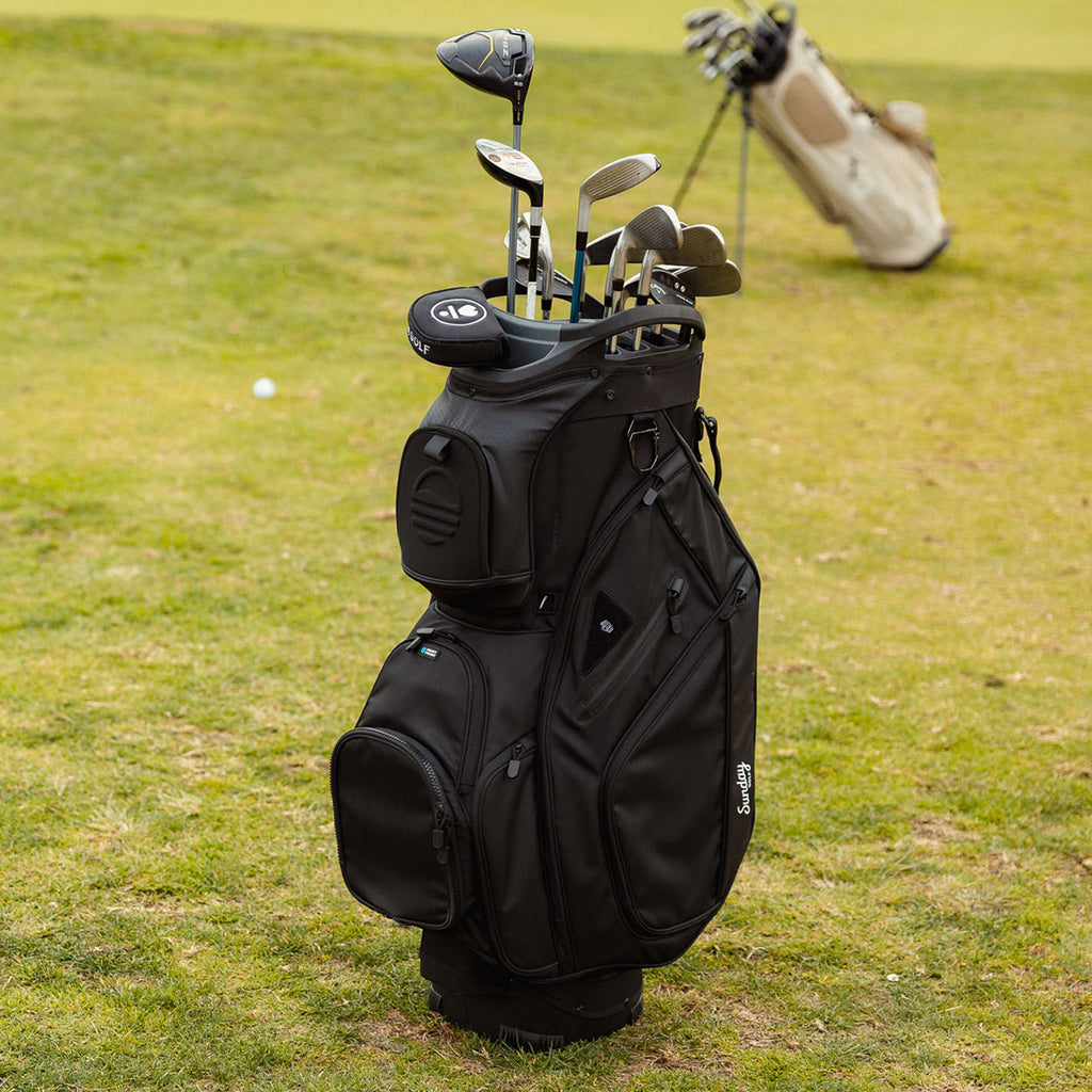 Front shot of Big Rig golf bag in matte black on the course with golf clubs inside