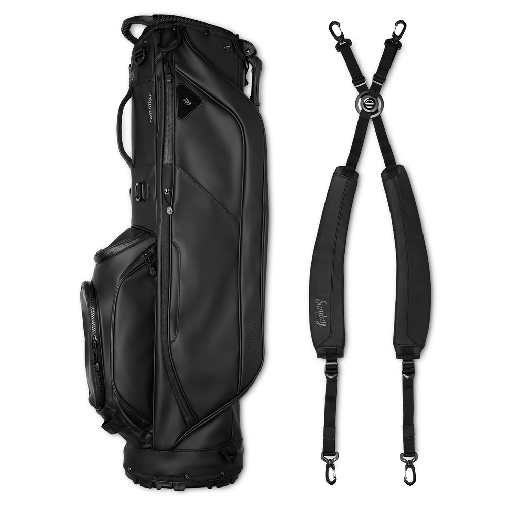 A full shot of Ryder S-Class golf bag in black vegan leather laying flat sideways beside its double strap
