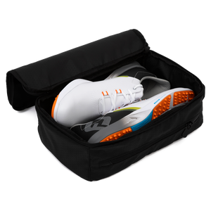 A pair of rubber shoes inside a golf shoe travel bag
