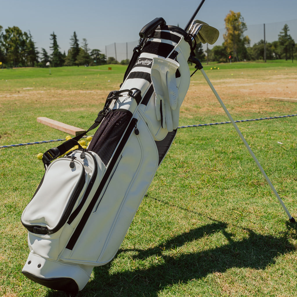 A full front shot on the course of standing Loma XL S-Class golf bag in white vegan leather