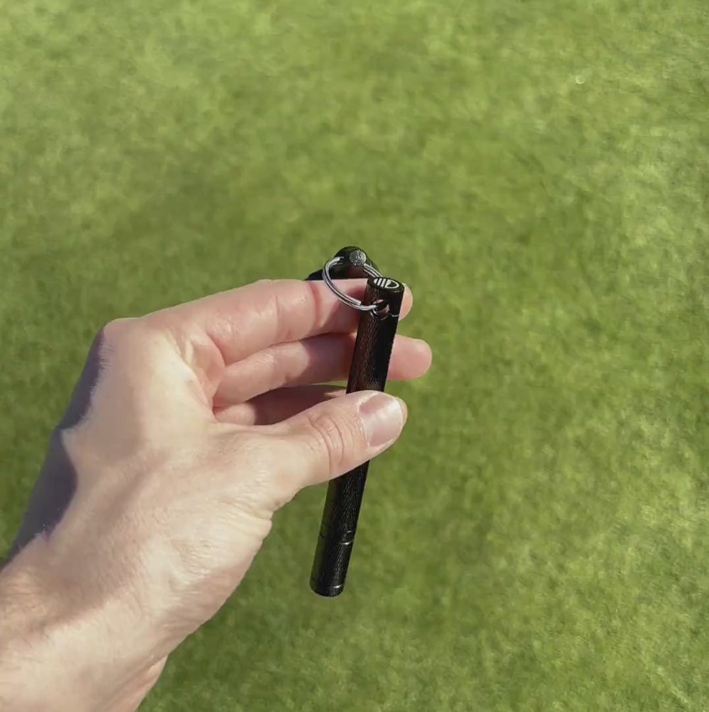 Groove sharpener in action, demonstrating usage and clipped securely to a golf bag