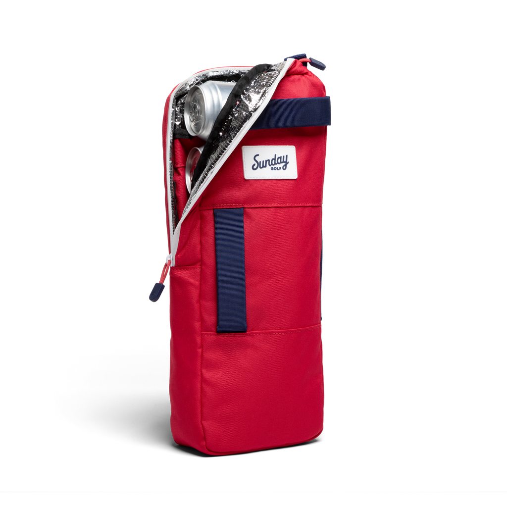 A front shot of big frosty golf cooler bag in red and blue unzipped showing canned drinks inside