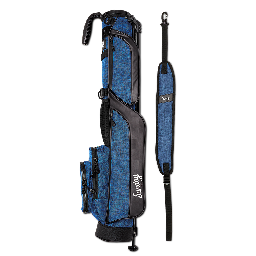 A full shot of The Loma golf bag in cobalt blue laying flat sideways beside its single strap