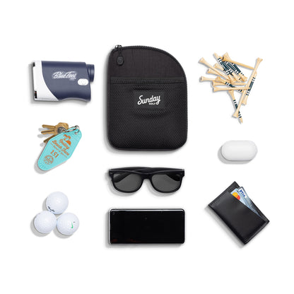 Matte black nickel bag valuables pouch laying flat with items it can hold 
