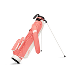 A full front shot of standing Loma golf bag in coral with single strap