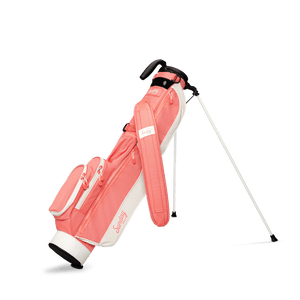 A full front shot of standing Loma golf bag in coral with single strap