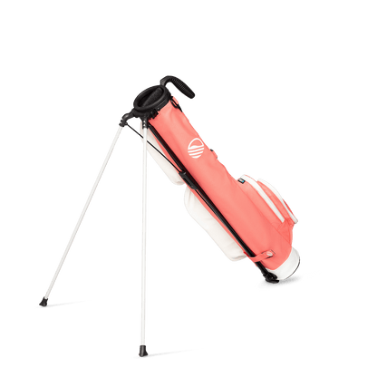 A full shot of standing Loma golf bag in coral facing backward