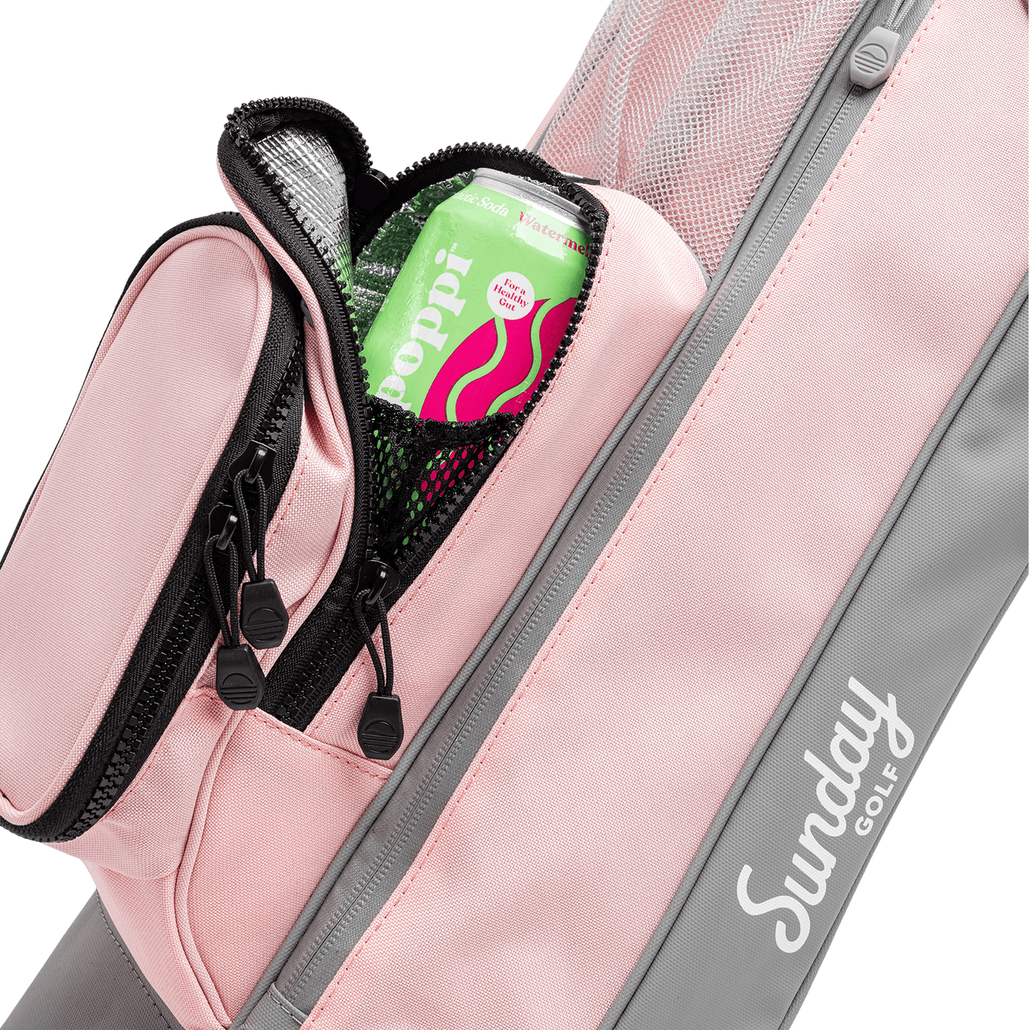 A close up shot of flamingo pink Loma golf bag's frosty pocket with a canned drink inside