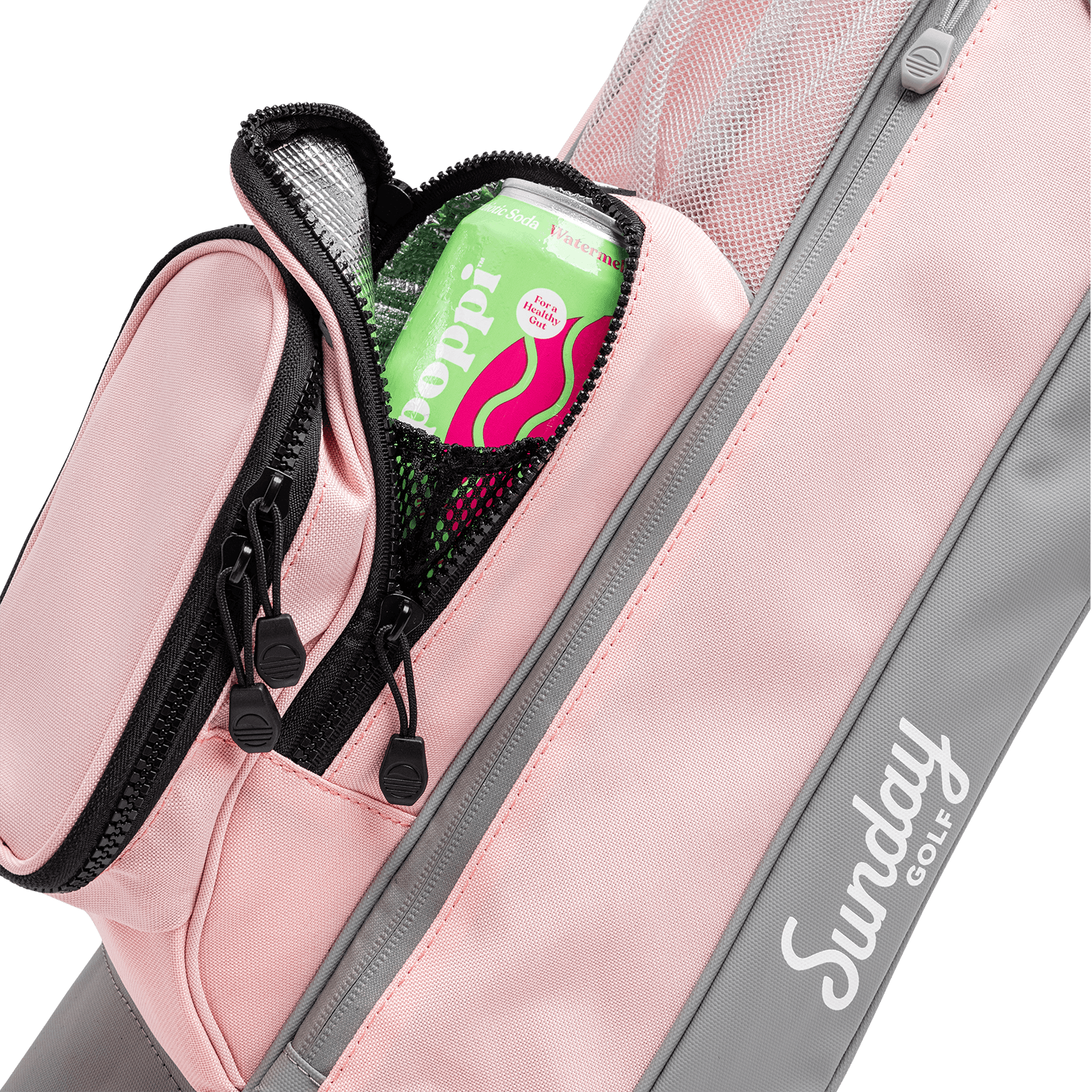 A close up shot of flamingo pink Loma golf bag's frosty pocket with a canned drink inside