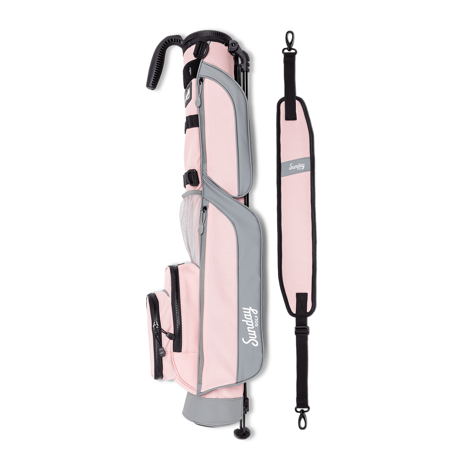 A full shot of Loma golf bag in flamingo pink laying flat sideways beside its single strap