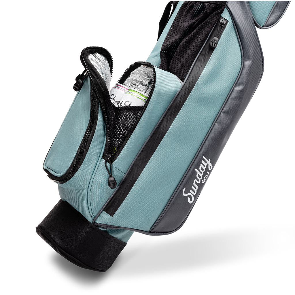 A close up shot of seafoam Loma golf bag's insulated pocket with canned drinks inside