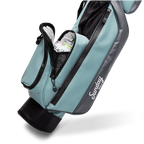 A close up shot of seafoam Loma golf bag's insulated pocket with canned drinks inside