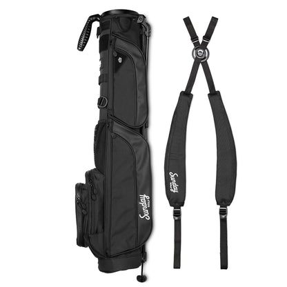 A full shot of Loma XL golf bag in matte black laying flat sideways beside its double strap