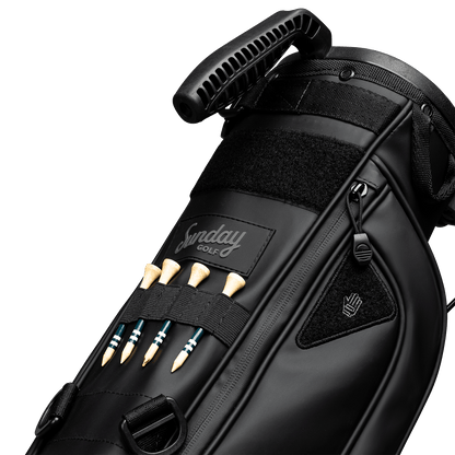 A close up of Loma XL S-Class golf bag in black vegan leather showing the front with bamboo golf tees